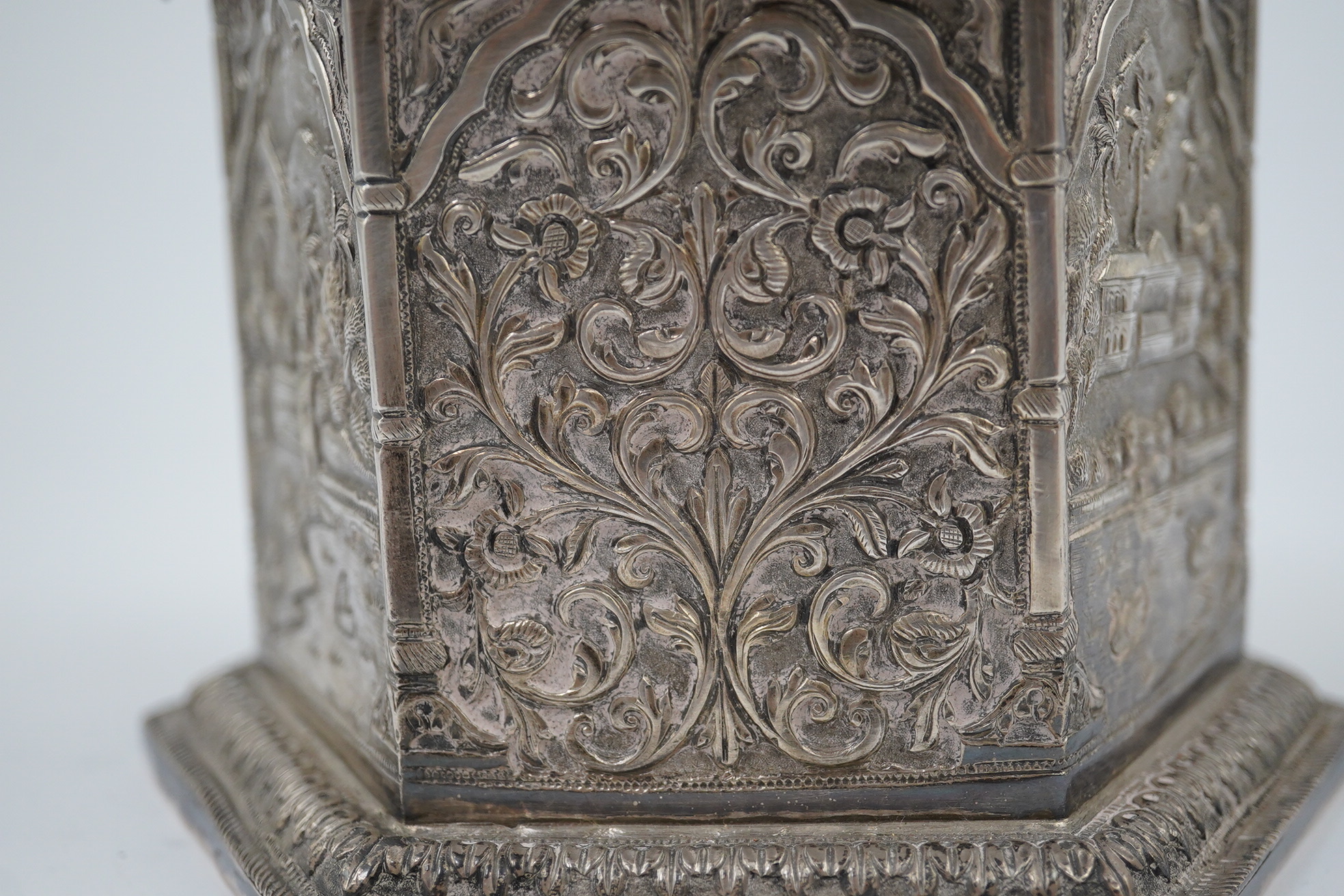 An early 20th century Indian embossed silver hexagonal box with fluted domed hinged cover